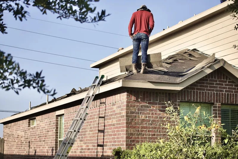 Professional roofer working on a residential roof in Agawam Town